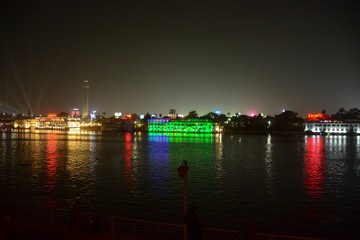 Beautiful view of river nile during night in Cairo Egypt showing light reflection from surrounding buildings and bouts