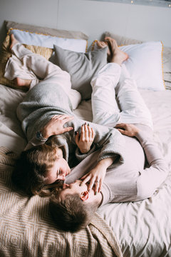 Beautiful loving couple hugging lying in bed