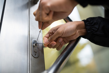 Close-up Of Male Lockpicker Fixing Door Handle At Home