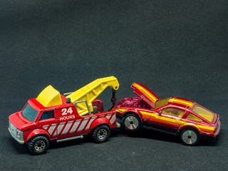 The tow truck pulling a car - small car models (toys)