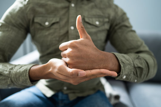 Man Using Sign Language To Communicate Against