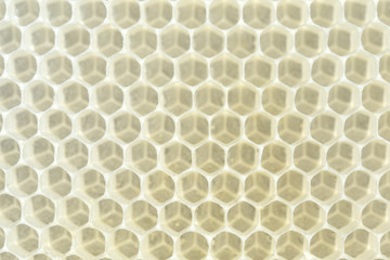  Yellow beeswax clear hexagon background. Natural honeycomb background. Close-up.