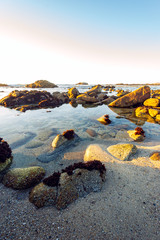 sunset on rocky coast of the sea