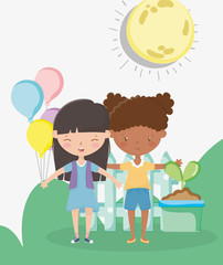 kids zone, happy little girls with balloons potted plant fence sun grass outdoors
