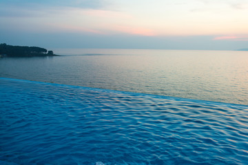 Swimming Pool with sunset on the sea