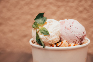ice cream with sprig of mint in paper cup