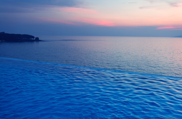 Swimming Pool with sunset on the sea