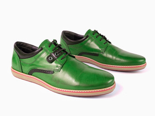 Pair of male green leather shoes on white background, isolated product, top view.