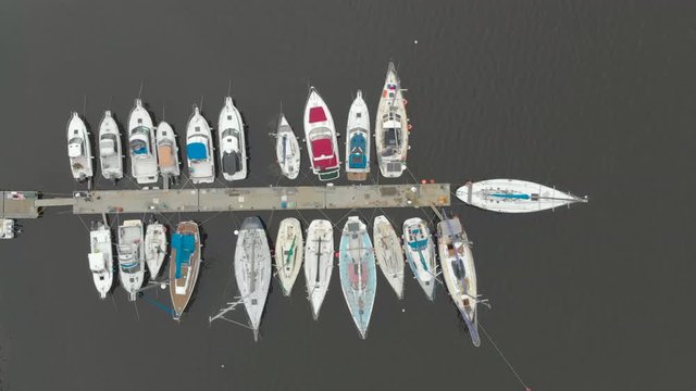 Aerial view on a yaght and boats parking in a calm bay