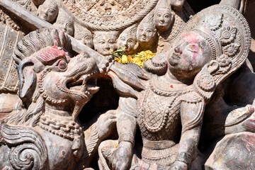 Stone image of a goddess and a lion in a temple in the ancient city of Bhaktapur