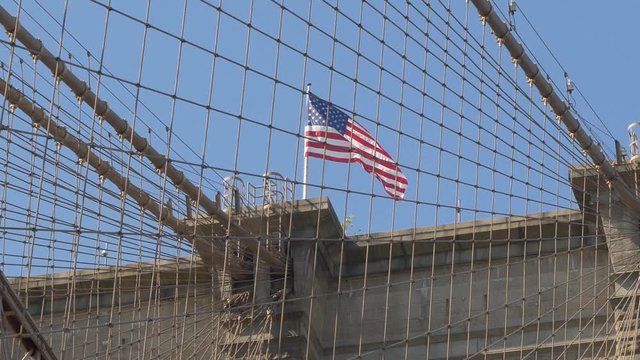 American Flag and Brooklyn Bridge Tower / Cables with American Flag waving in the Breeze