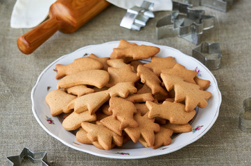 Christmas cookies in a white plate on a textile background
