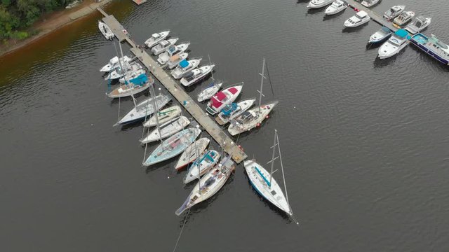 Aerial view on a yaght and boats parking in a calm bay