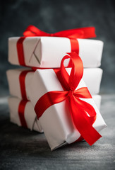 Christmas gift with red ribbon on the gray concrete background. Christmas and New Year background.