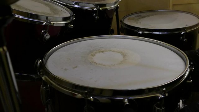 Young child plays drums on drumset