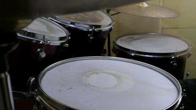 Young child plays drums on drumset