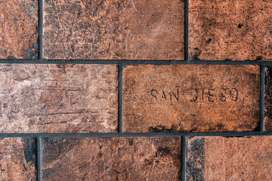 Vintage brick wall background texture of interior tiles . Wallpaper pattern with American city names on it. 
