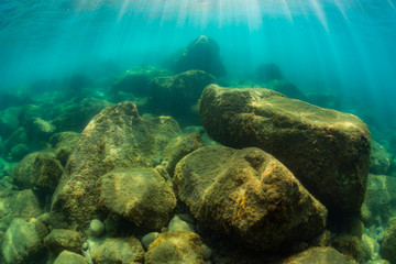 Rays of sunlight shining into sea, underwater view