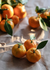 Fresh mandarins closeup with strong sun lights at wooden background