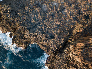 Top dow view of rock formation on the ocean coastline.