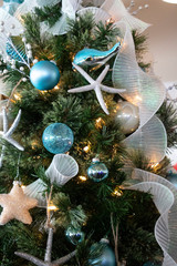 Under the Sea Christmas Tree Detail. Close up of a ocean themed Christmas tree. Whimsical and unique nautical holiday decorations. Winter holiday meats the crashing water. Starfish and sea creatures.