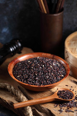 close up riceberry rice in measuring cup on table, riceberry rice in chinese kitchen background