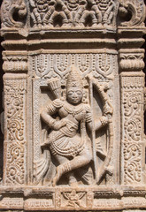 An ancient sculpture of the Hindu god Rama carved into a temple column.