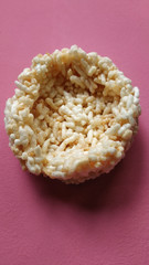 Rengginang.  Traditional Indonesian Snack Made from Rice and Fried. Crunchy and Crispy Snack.  Isolated on Pink Background