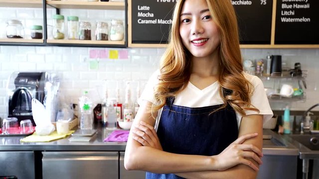 Pretty young asian waitress standing arms crossed in cafeteria. Owner Young Entrepreneur Passion .Small business owner Korean girl in apron relax toothy smile looking.