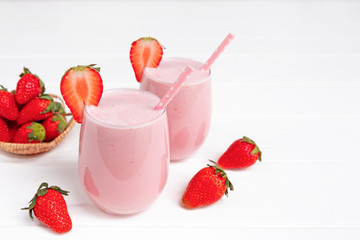 Strawberry yogurt fruit juice smoothie pink colorful fruit juice milkshake blend beverage healthy high protein the taste yummy In glass drink episode morning on white wood background.