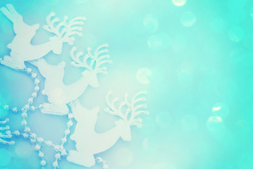 Obraz premium Reindeer glitter on bright blue Christmas card. Beautiful Christmas background with reindeer and place for text.
