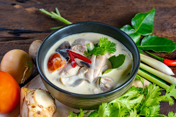 Coconut milk soup with chicken and Thai ingredients on the table,  Thai food that is popular in Thailand.