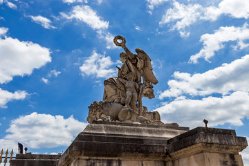 An allegorical sculpture group at the entrance gate of the Palace of Versailles