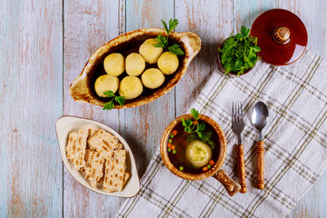 Traditional Jewish matzah ball soup, matzo and matzo balls.
