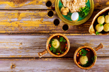 Passover jewish food. Pesach matzo balls soup and matzoh bread, wine, seder plate.
