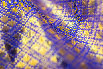 Close up of silk, satin luxury cloth texture ,modern pattern, golden and violet Thai silk textured...