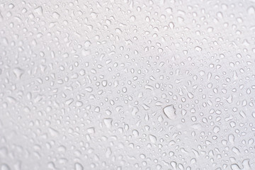 Water​ rain​ drops​ on​ white fabric tent​ background