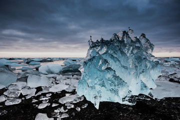 Diamond beach in Iceland on the Atlantic ocean coast. Icebergs from Jokulsarlon glacier lagoon
