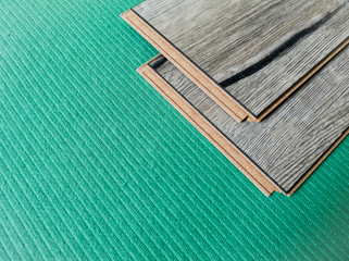 Two laminate boards lie on an environmentally friendly substrate of natural needles