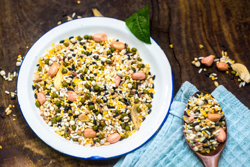 The white container holds the raw material of the eight treasures grain porridge on the board