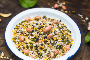 The white container holds the raw material of the eight treasures grain porridge on the board