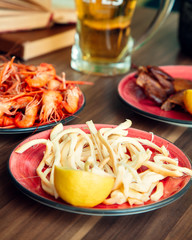 beer snacks with cheese and lemon plate and shrimp plate