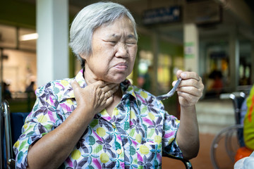 Asian senior woman suffers from choke,clogged up food,elderly people choking during feeding,food...