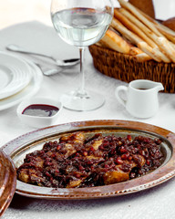 roasted lamb garnished with pomegranate and onion