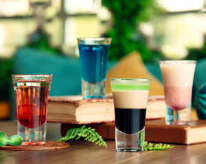 four shot glasses placed on the table