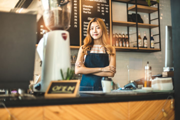 Portrait young Asian woman barista feeling happy smiling at urban cafe. Small business owner Korean girl in apron relax toothy smile