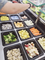Woman Choosing fresh healthy food Salad vegetables In Supermarket