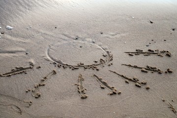 Drawn sun sign on tne beach