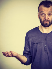 Confused adult man seeking for solution