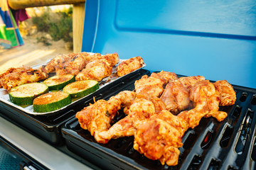 Chicken meat grilling on gas grill